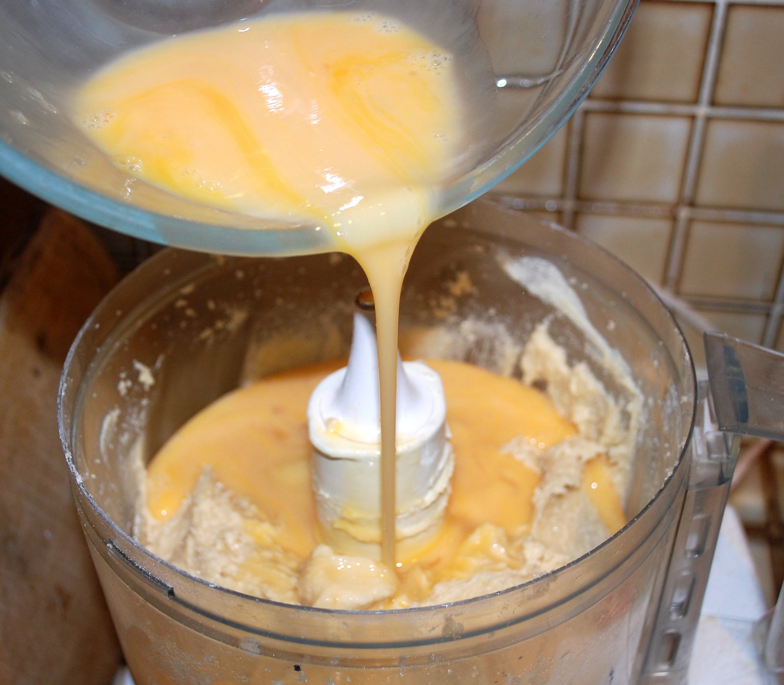 Pouring Eggs Into Batter For Almond Cake