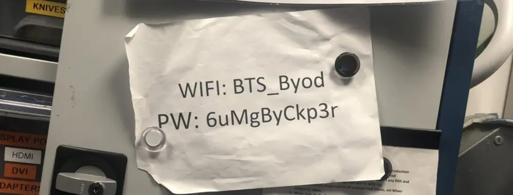 Photograph of paper attached to front of cabinet with WIFI username and password printed. 