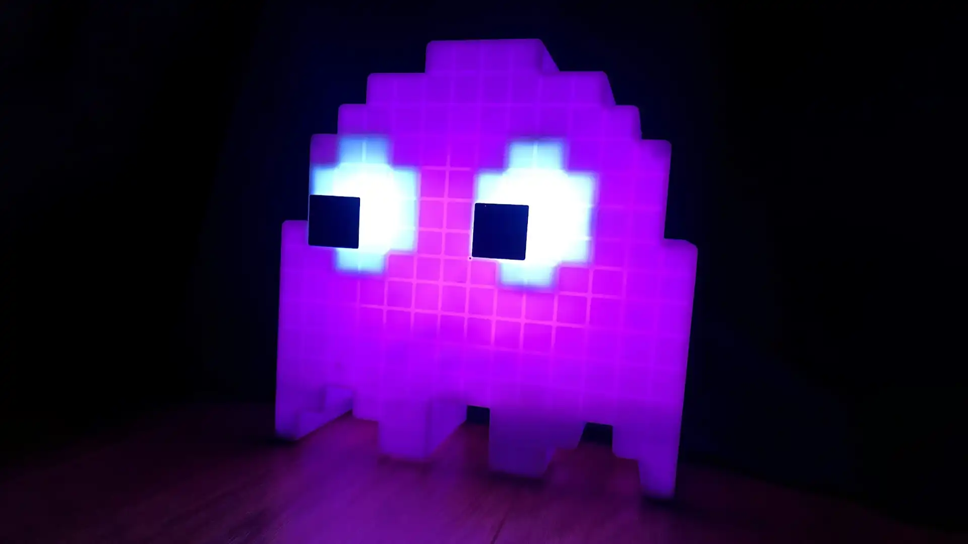 Photograph of purple glowing PAC-MAN Ghost on a black backdrop.