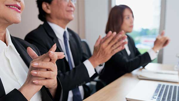 A local audience clapping at a business promo