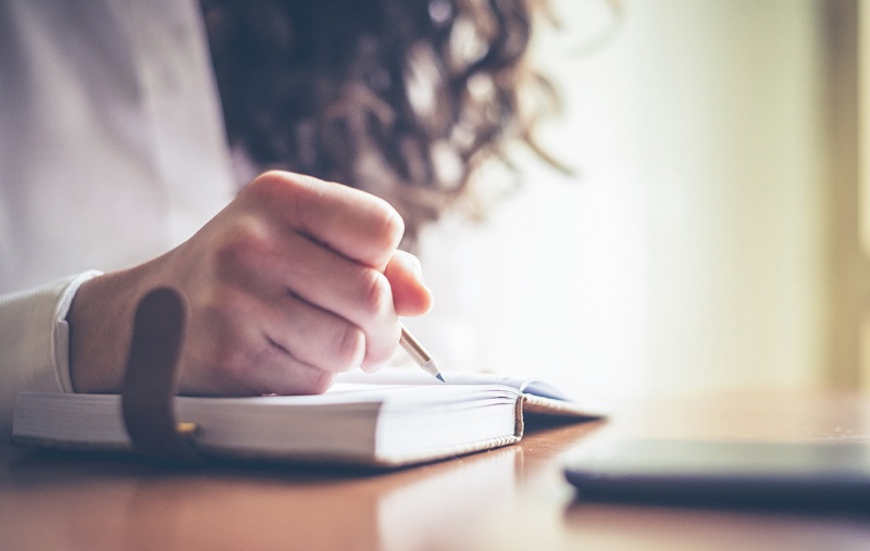 A person writing in a book