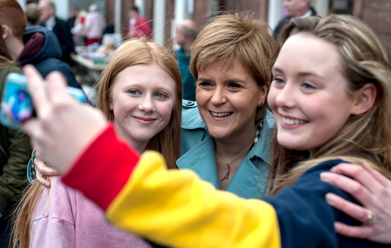 Nicola Sturgeon having her photograph taken with two young women