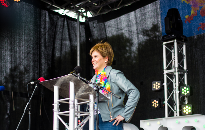 Nicola Sturgeon speaking at Pride Glasgow, wearing a rainbow flower necklace