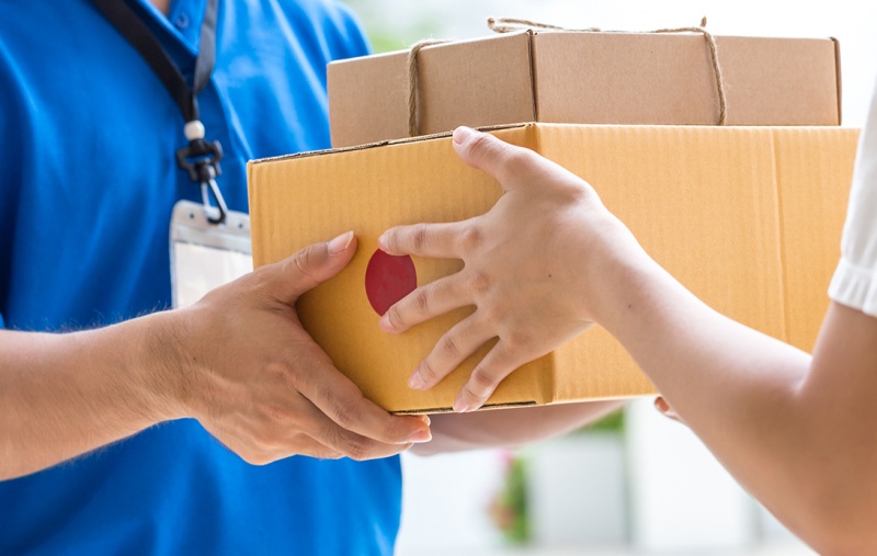 A person taking delivery of two parcels