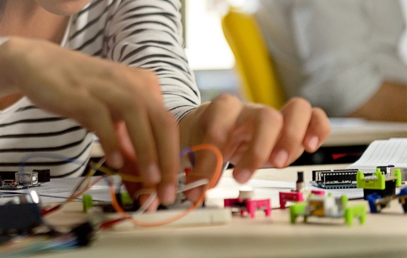 A young person tinkering with circuit boards