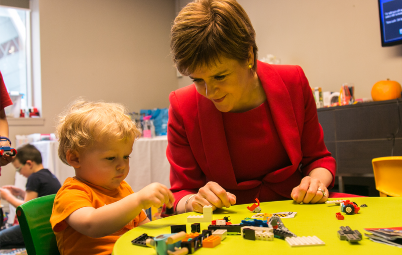 Nicola Sturgeon with a wee child at a nursery