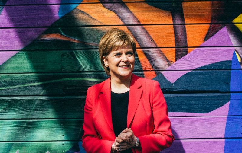 Nicola Sturgeon in front of a colourful wall