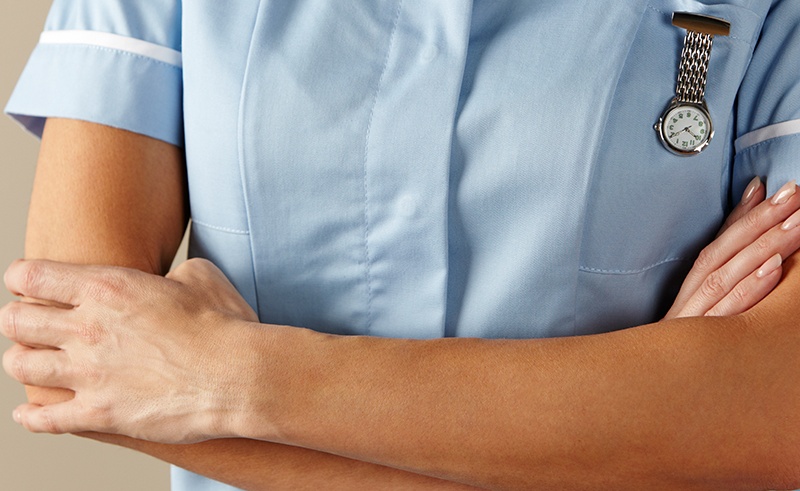 A nurse with her arms folded