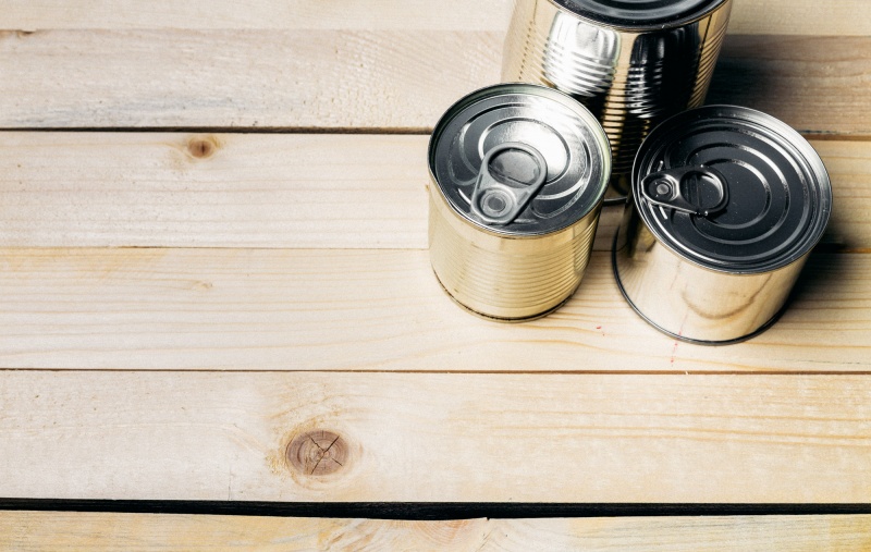 Tin cans for food on wooden background