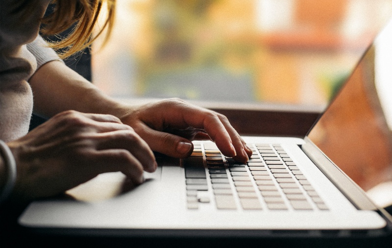 Close-up view on woman who working on laptop