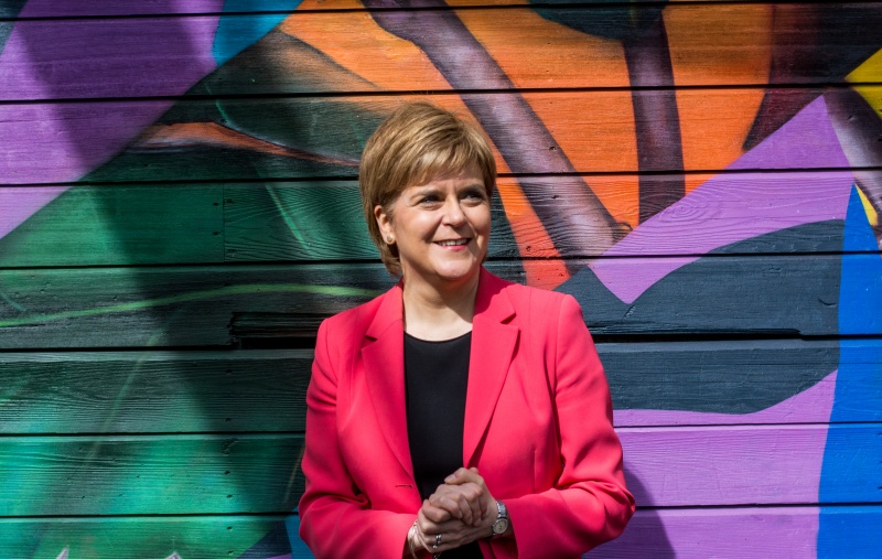 Nicola Sturgeon in front of a colourful wall