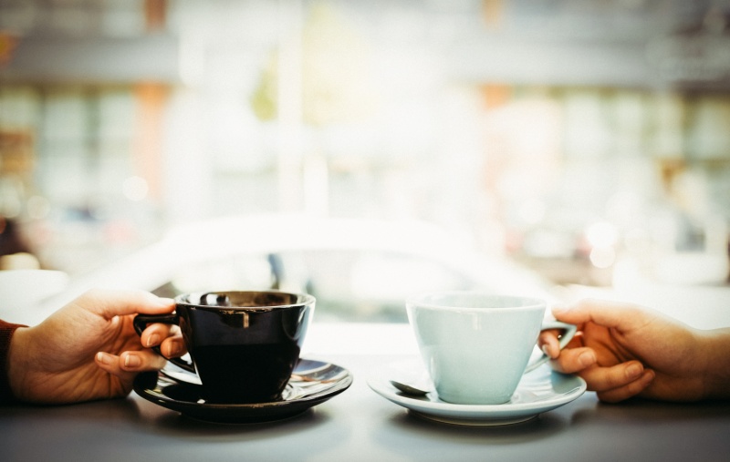 Friends holding cups of coffee