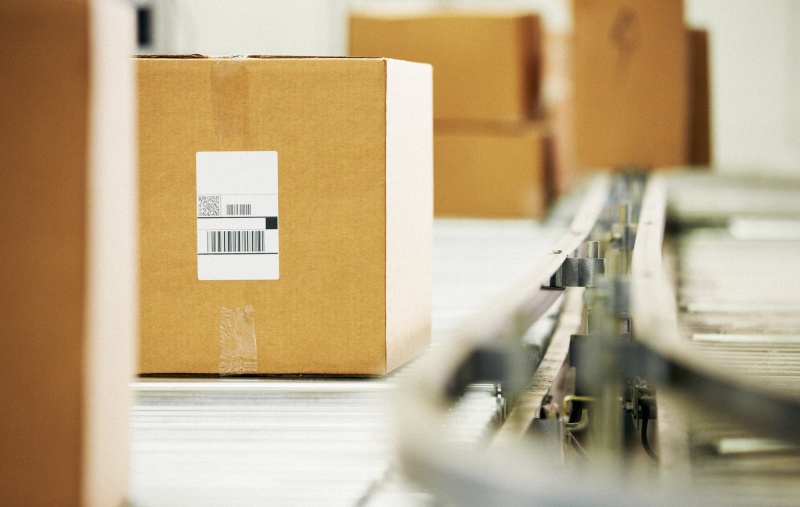 Goods On Conveyor Belt In Distribution Warehouse