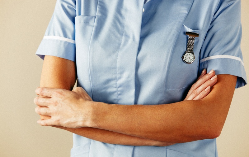 Nurse standing with her arms folded