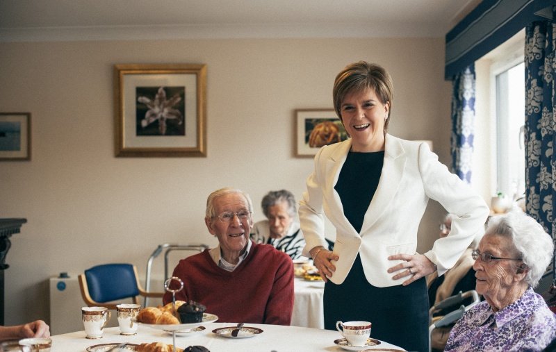 Nicola Sturgeon at a care home with two older people