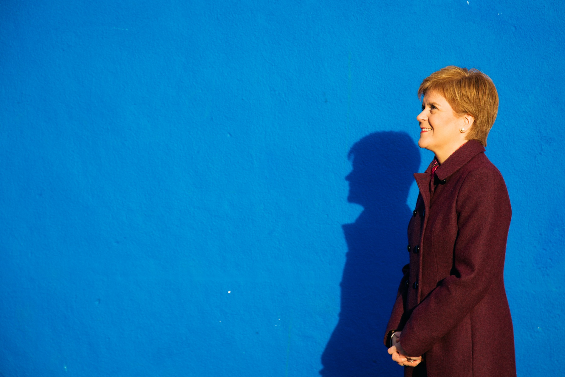 Nicola Sturgeon against a blue wall