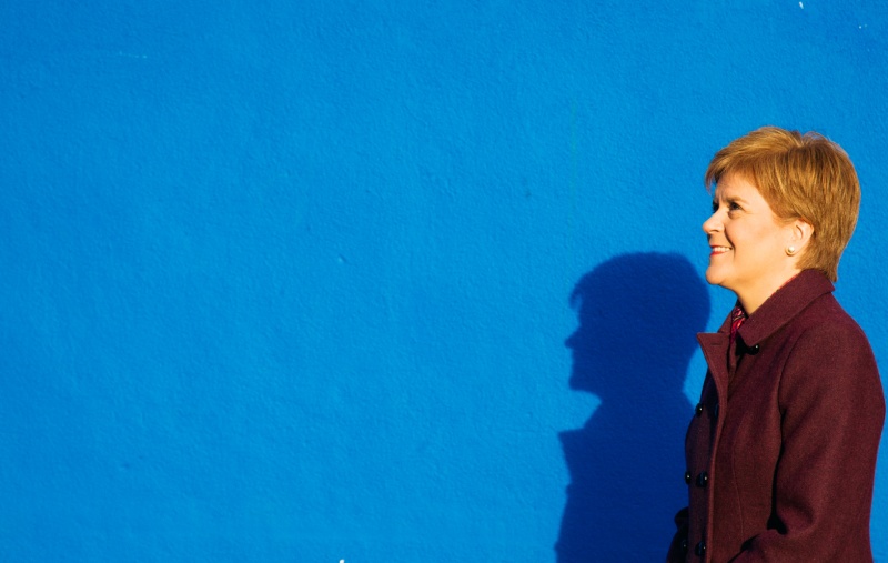 Nicola Sturgeon against a blue wall